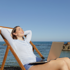 lady on beach with laptop